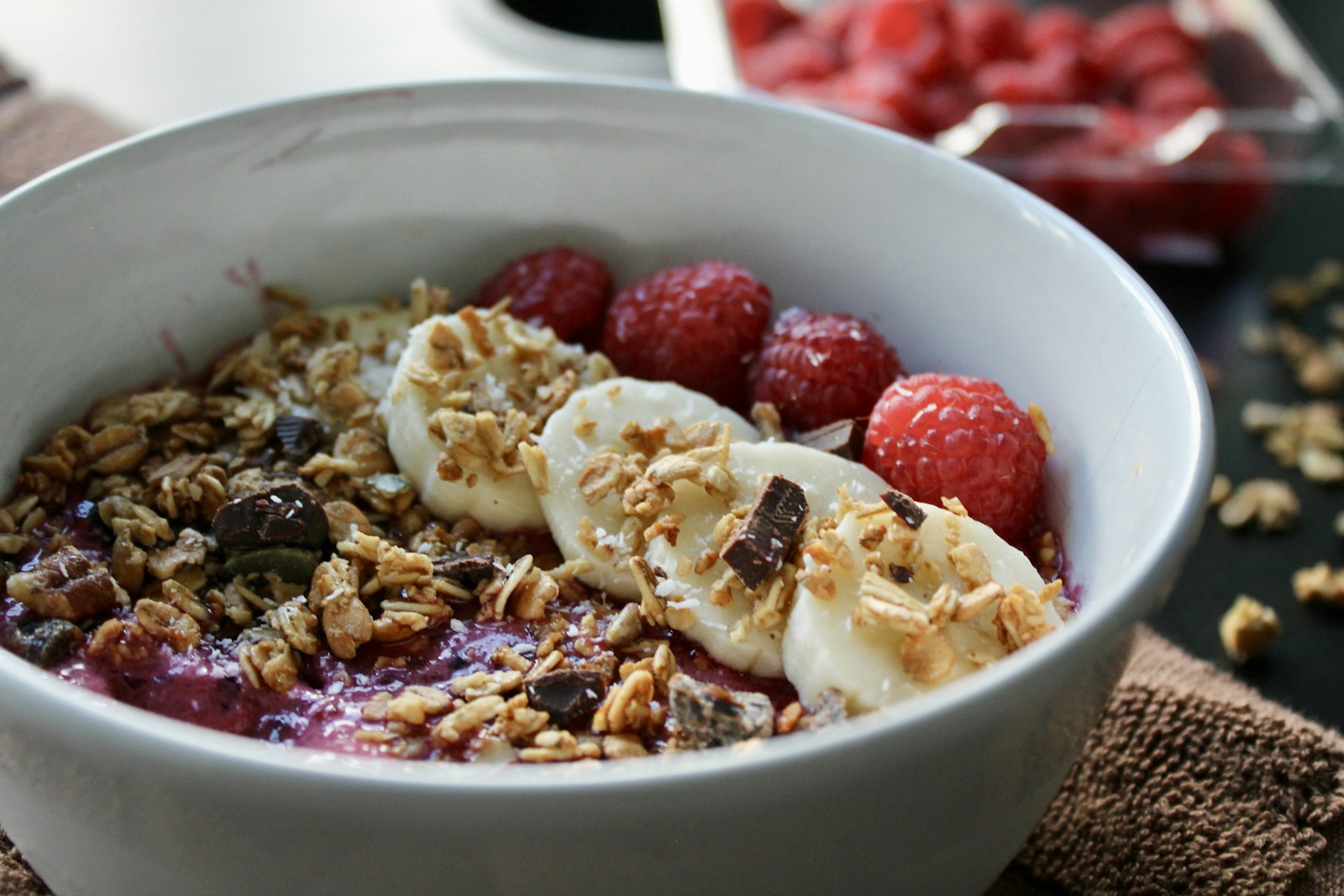 Acai with banana, raspberries, granola and chocolate