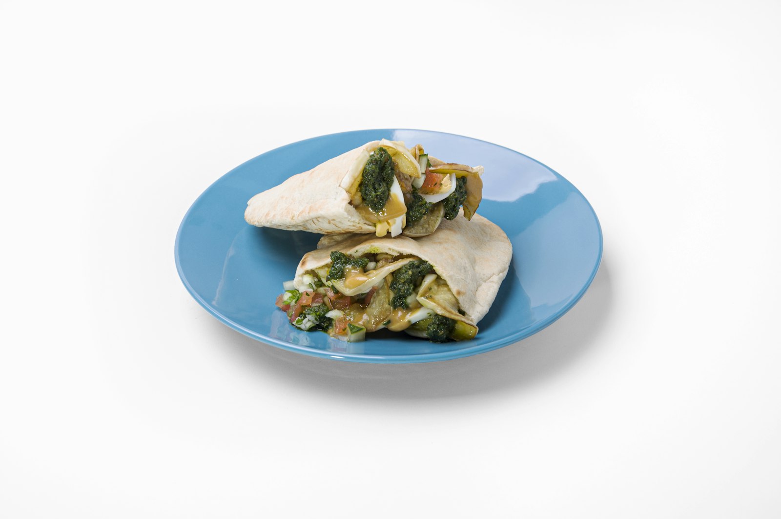 Hummus veggie wraps on a blue plate