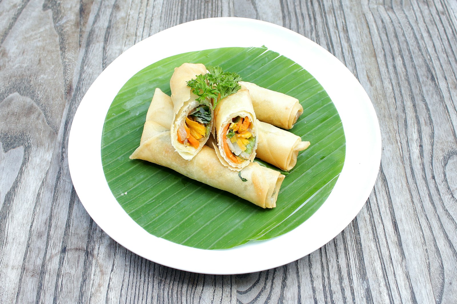 Baked spring rolls on a banana leaf