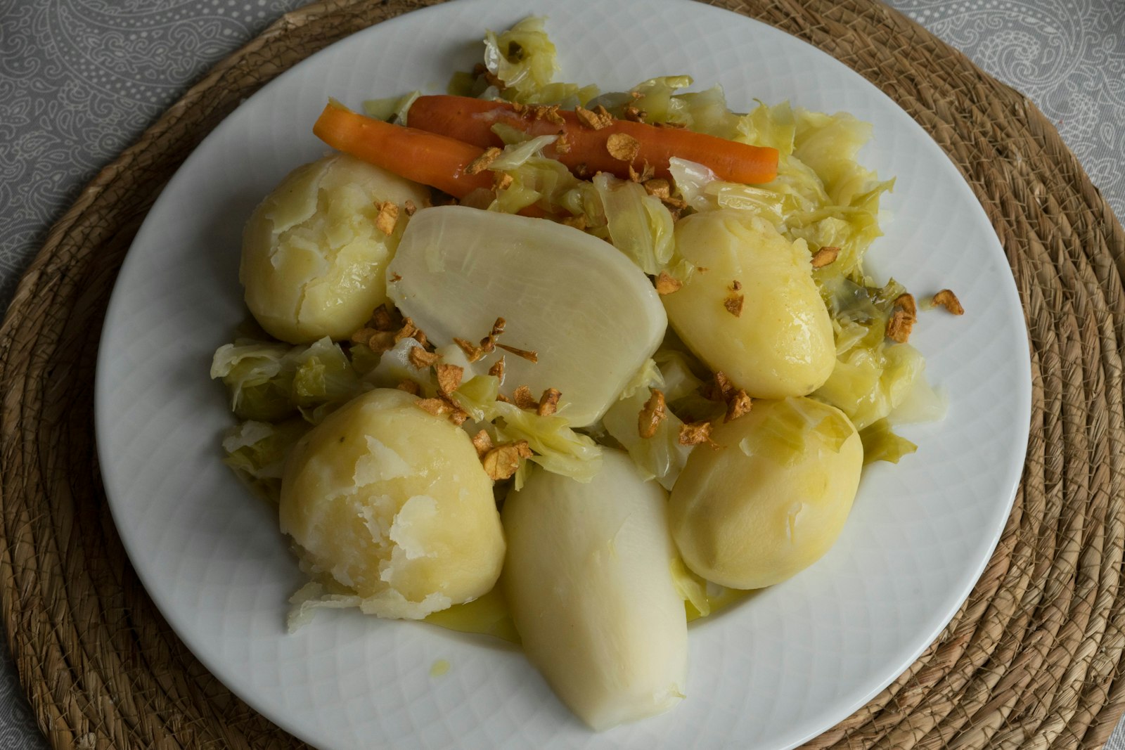 Boiled potatoes and greens on a plate
