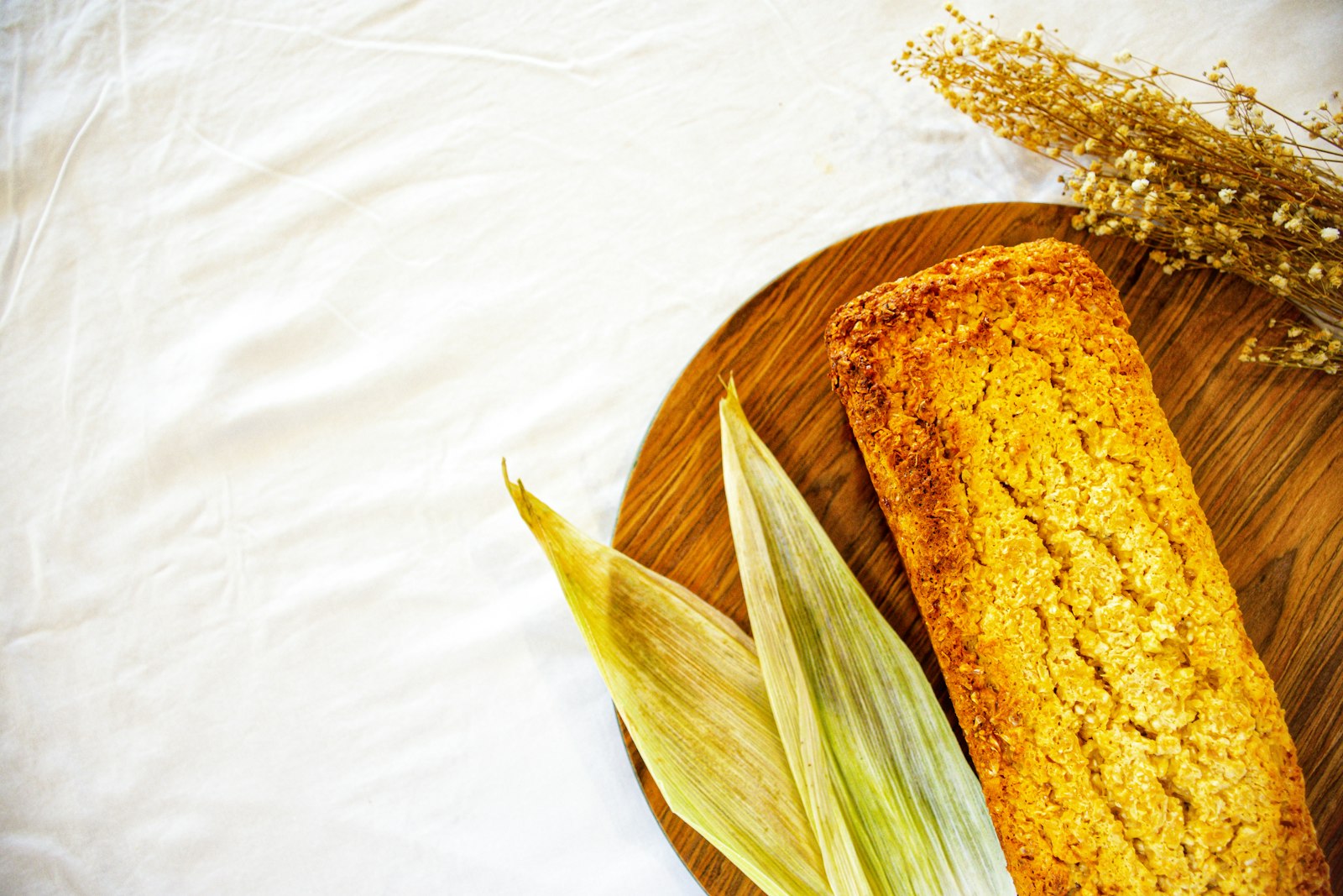 Golden cornbread loaf with corn husks
