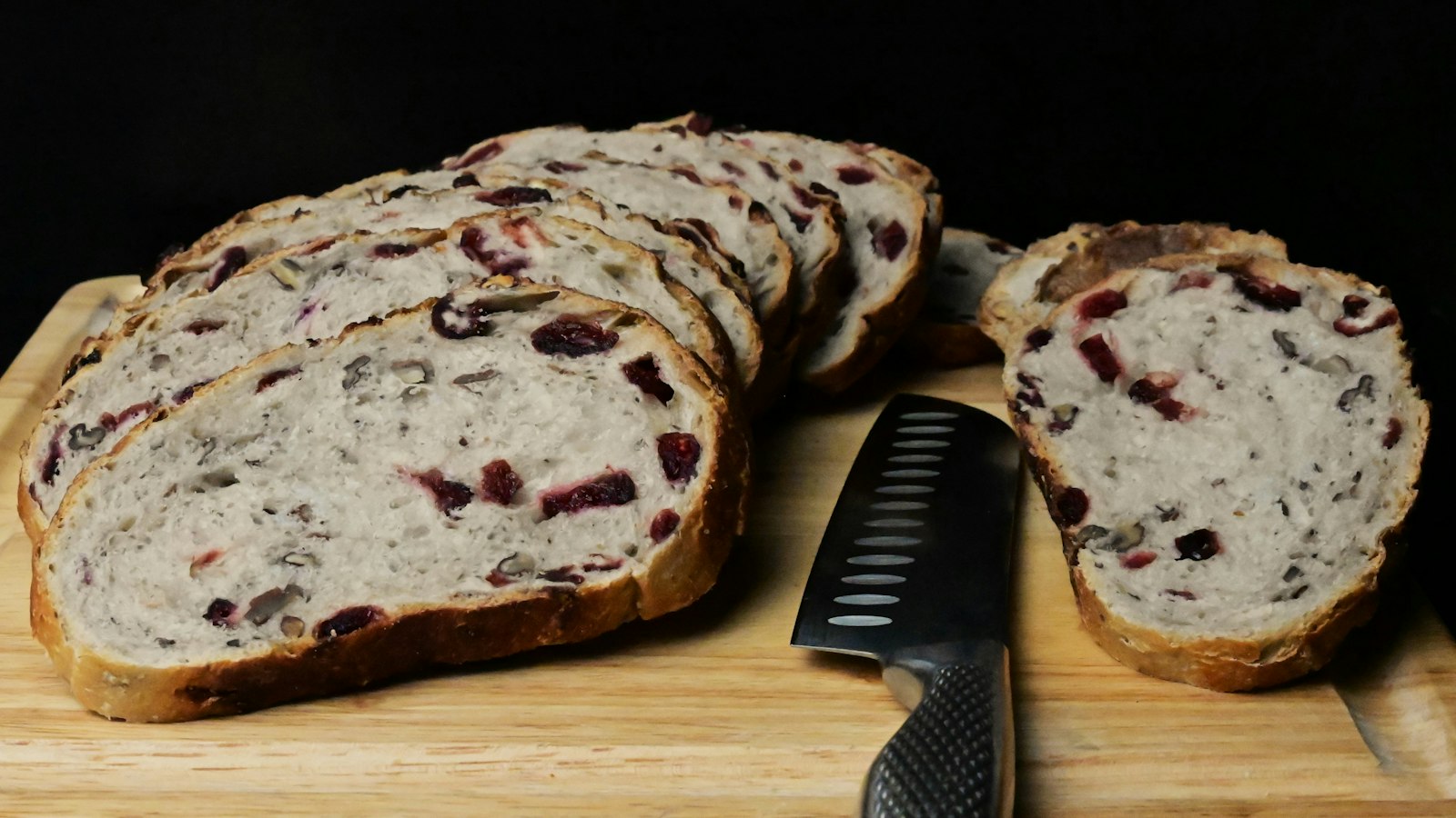 Cranberry orange quick breads sliced on a board