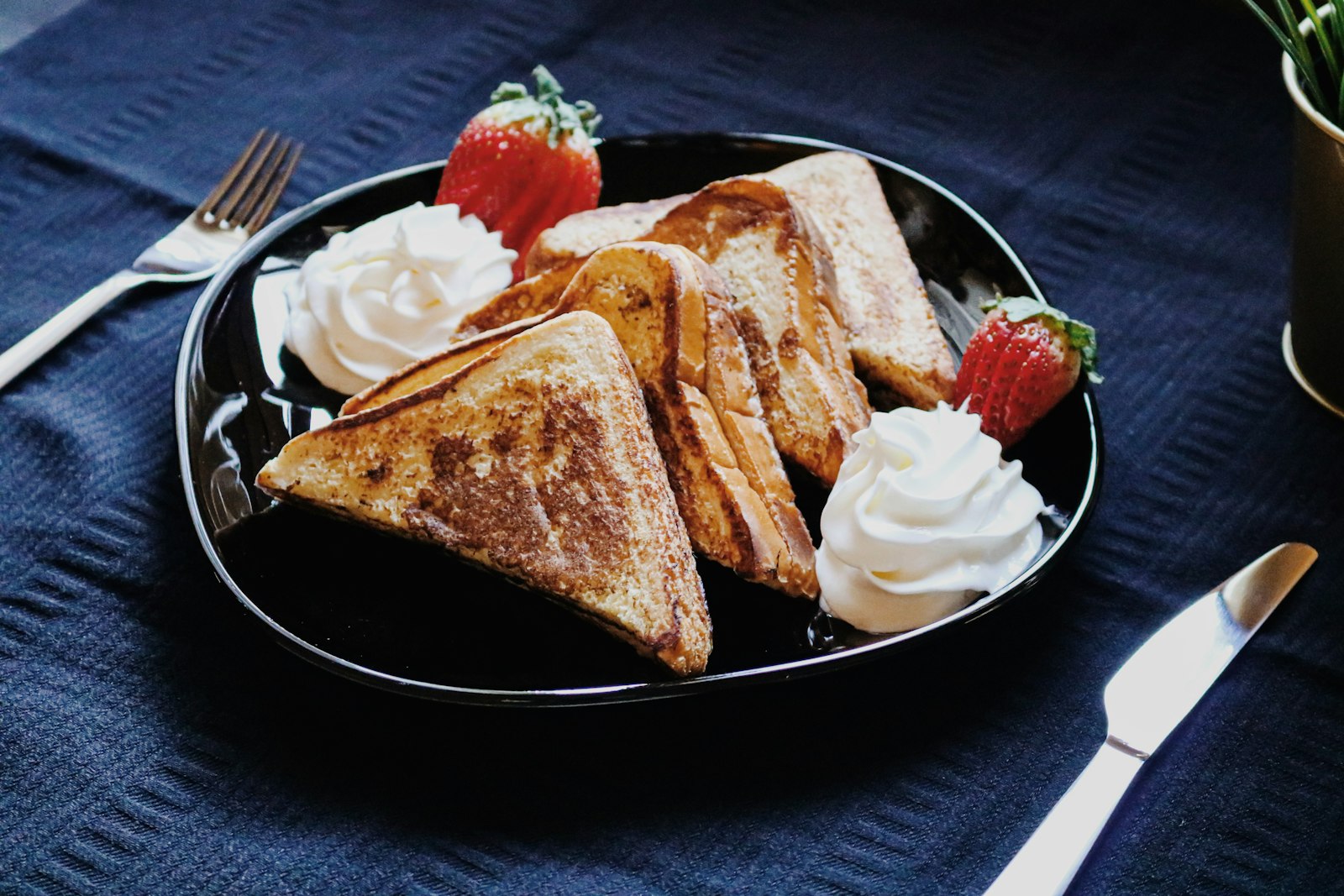 Stuffed French toast triangles with whipped cream and strawberries