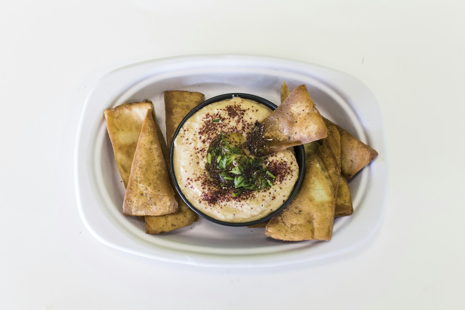 Classic hummus mezze with olive oil and pita chips