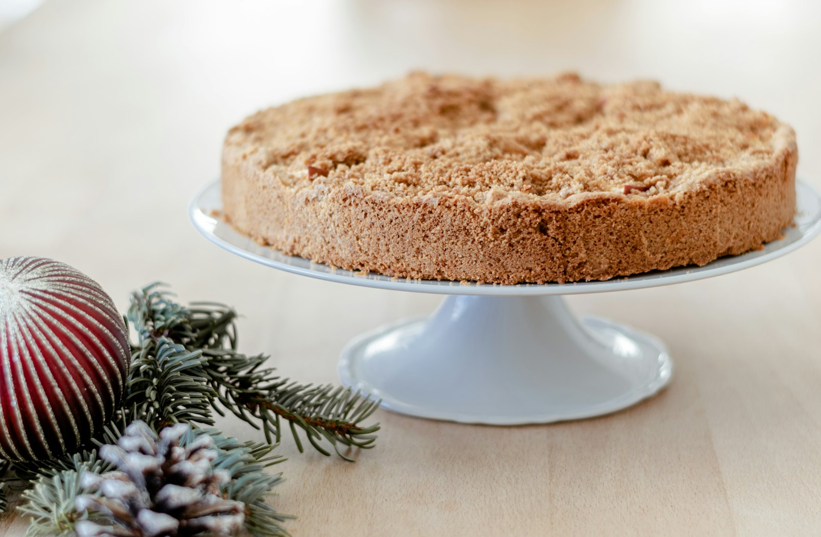 Apple crumb coffee cake on a white cake stand