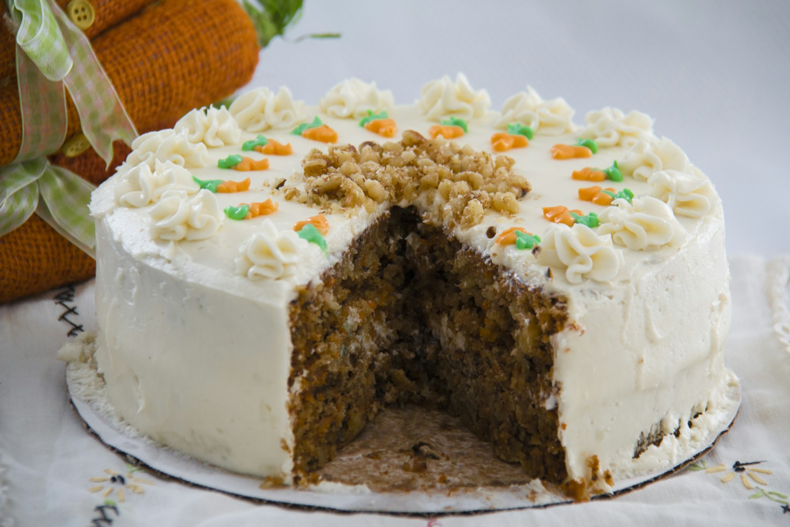 Frosted carrot cake with one slice cut out