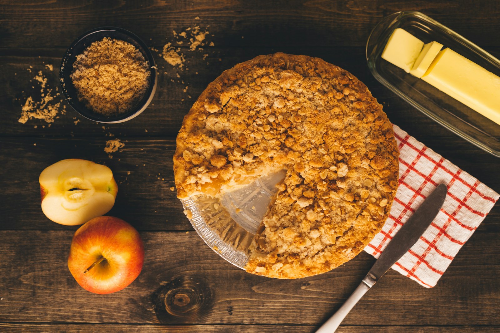 Apple crumble with fresh apples on the table