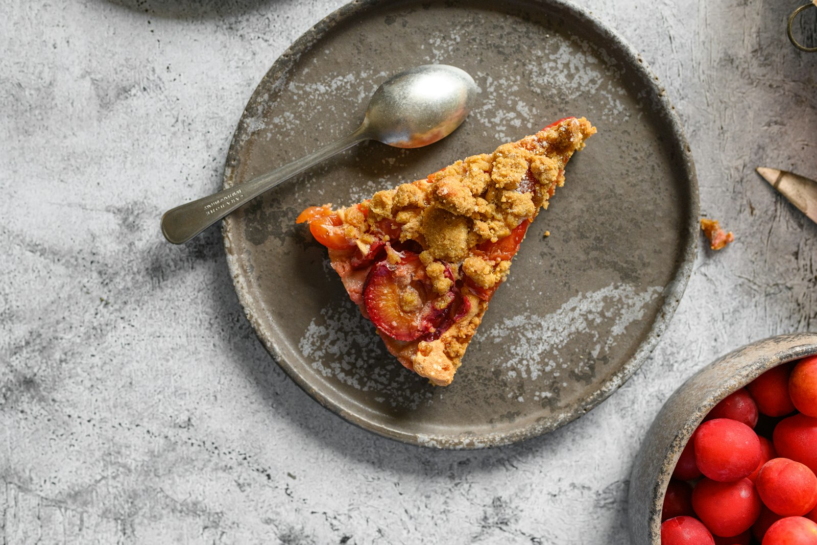 Slice of raspberry tart with oat topping