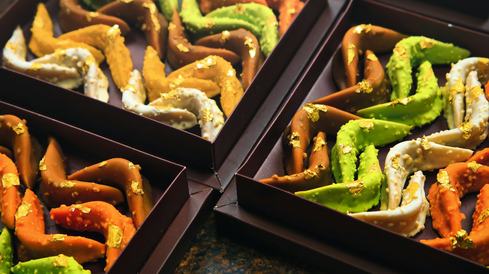 Chocolate dipped pretzel rods with colorful coatings
