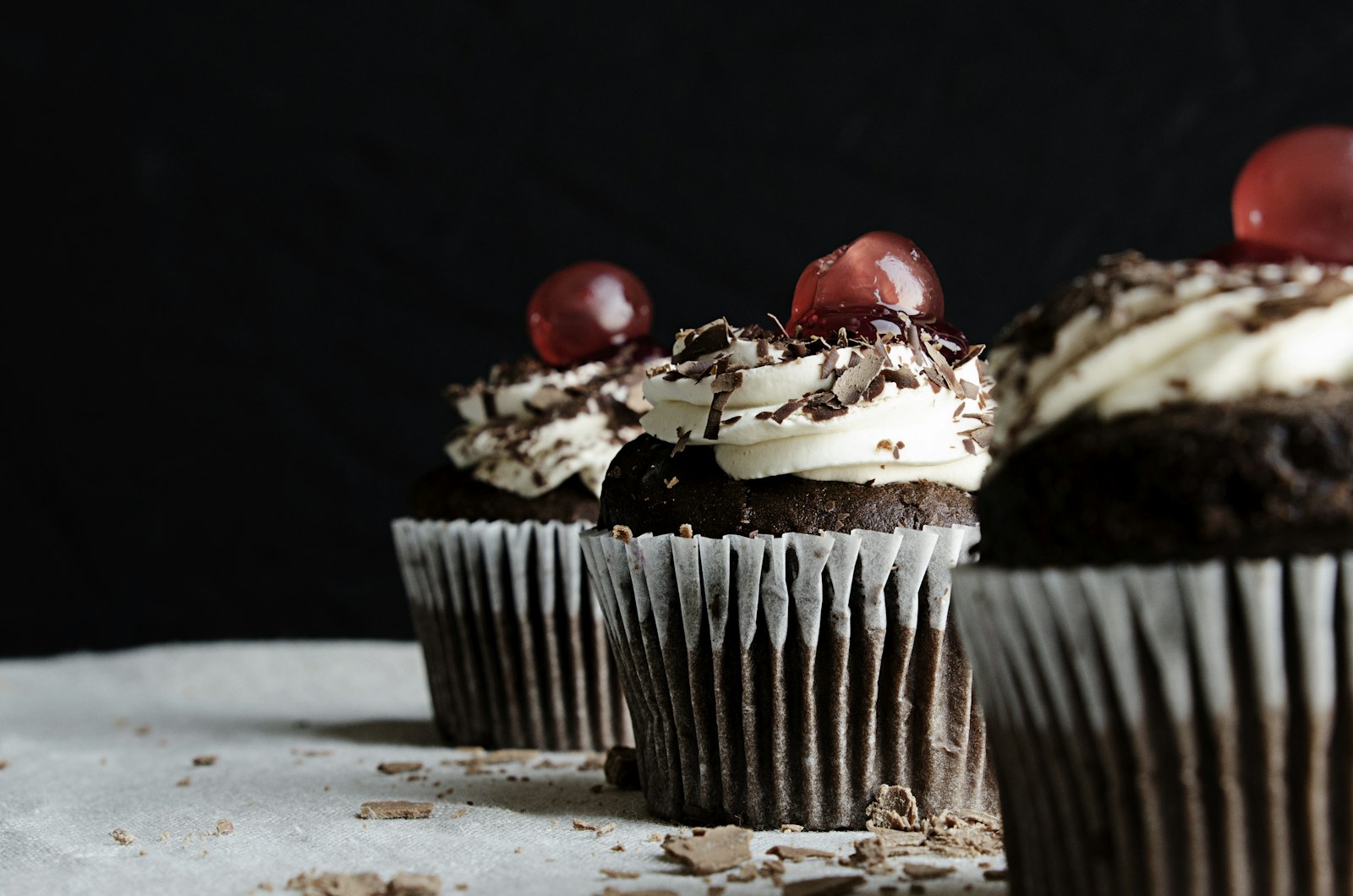 Chocolate cupcake with whipped cream and cherries