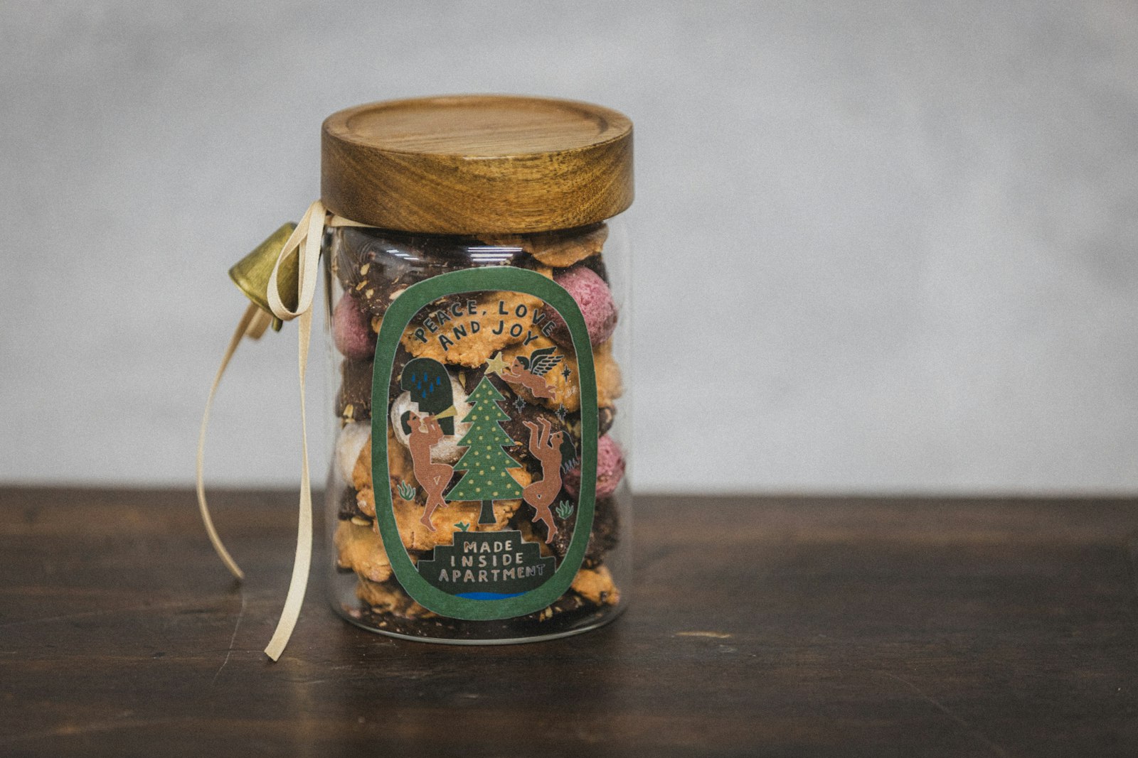 Decorated jar of cookies tied with ribbon as edible gifts