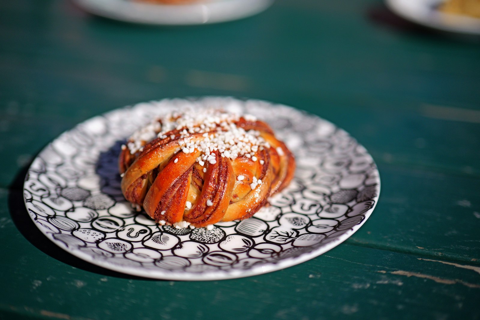 Swedish cardamom knot bun on a plate