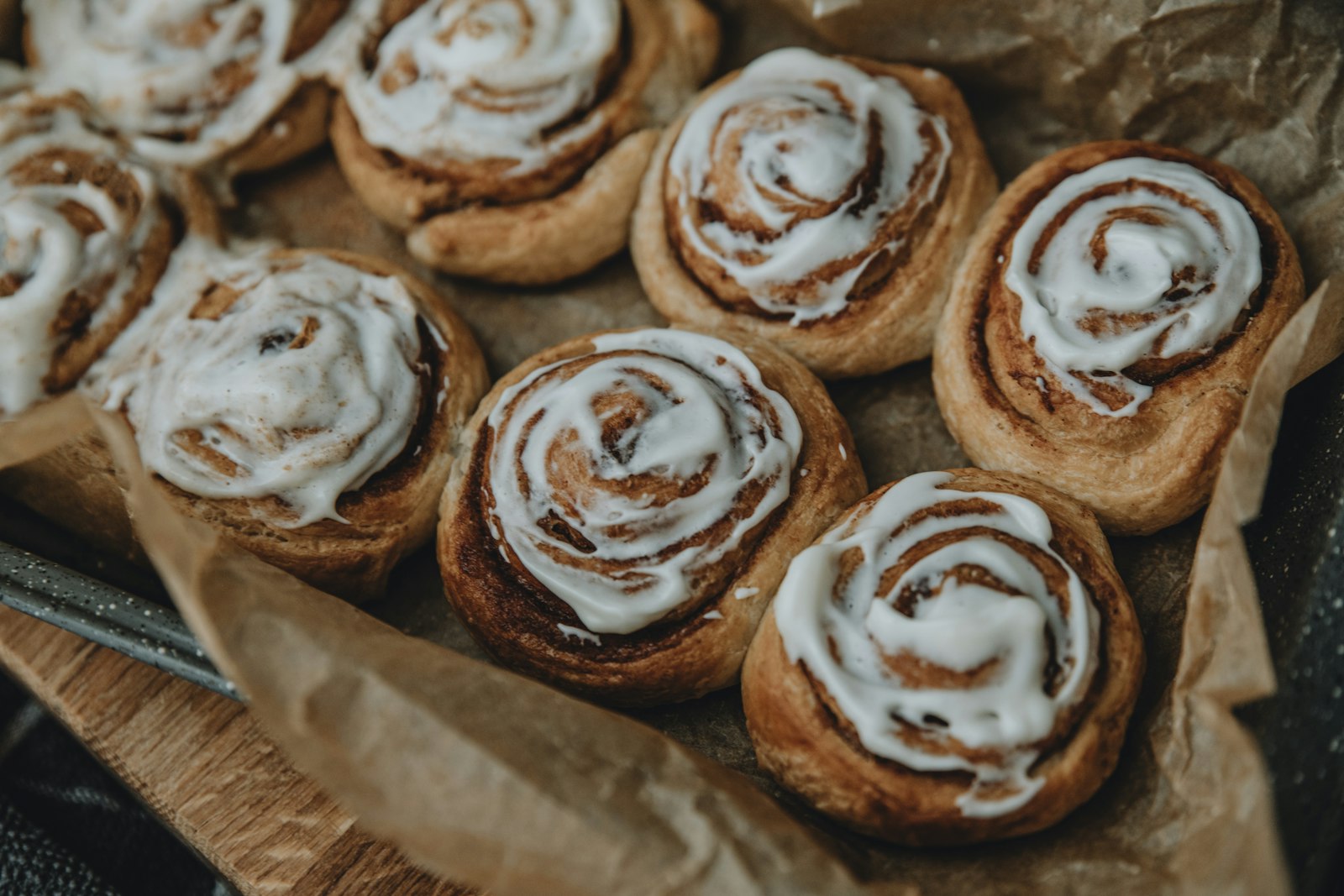 Cinnamon rolls with cream cheese frosting on a tray