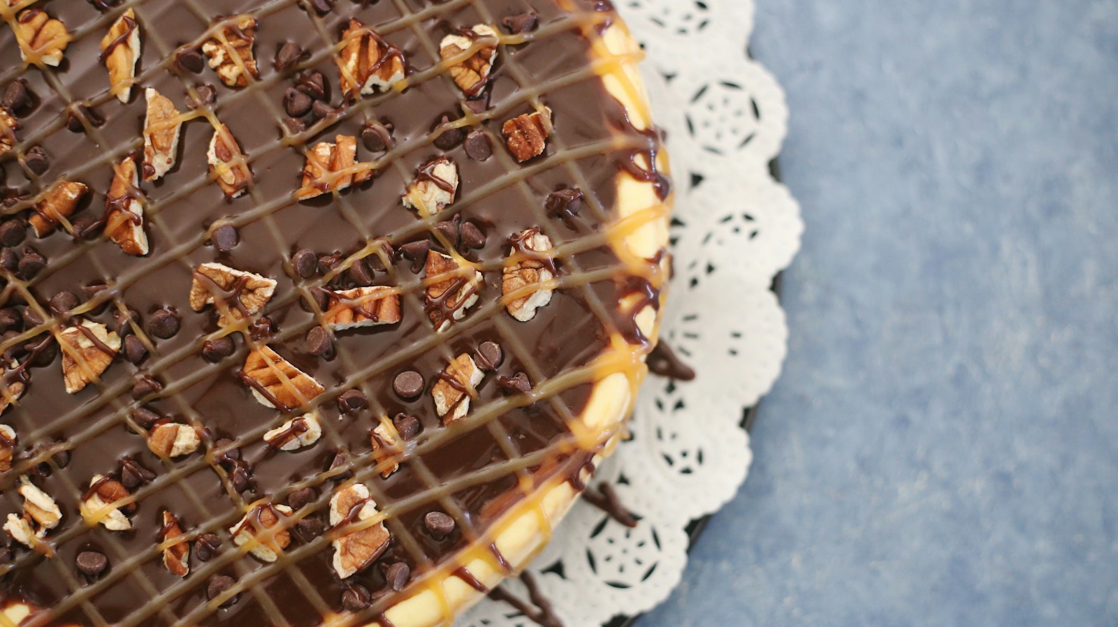 Chocolate caramel pecan turtle tart with a caramel drizzle