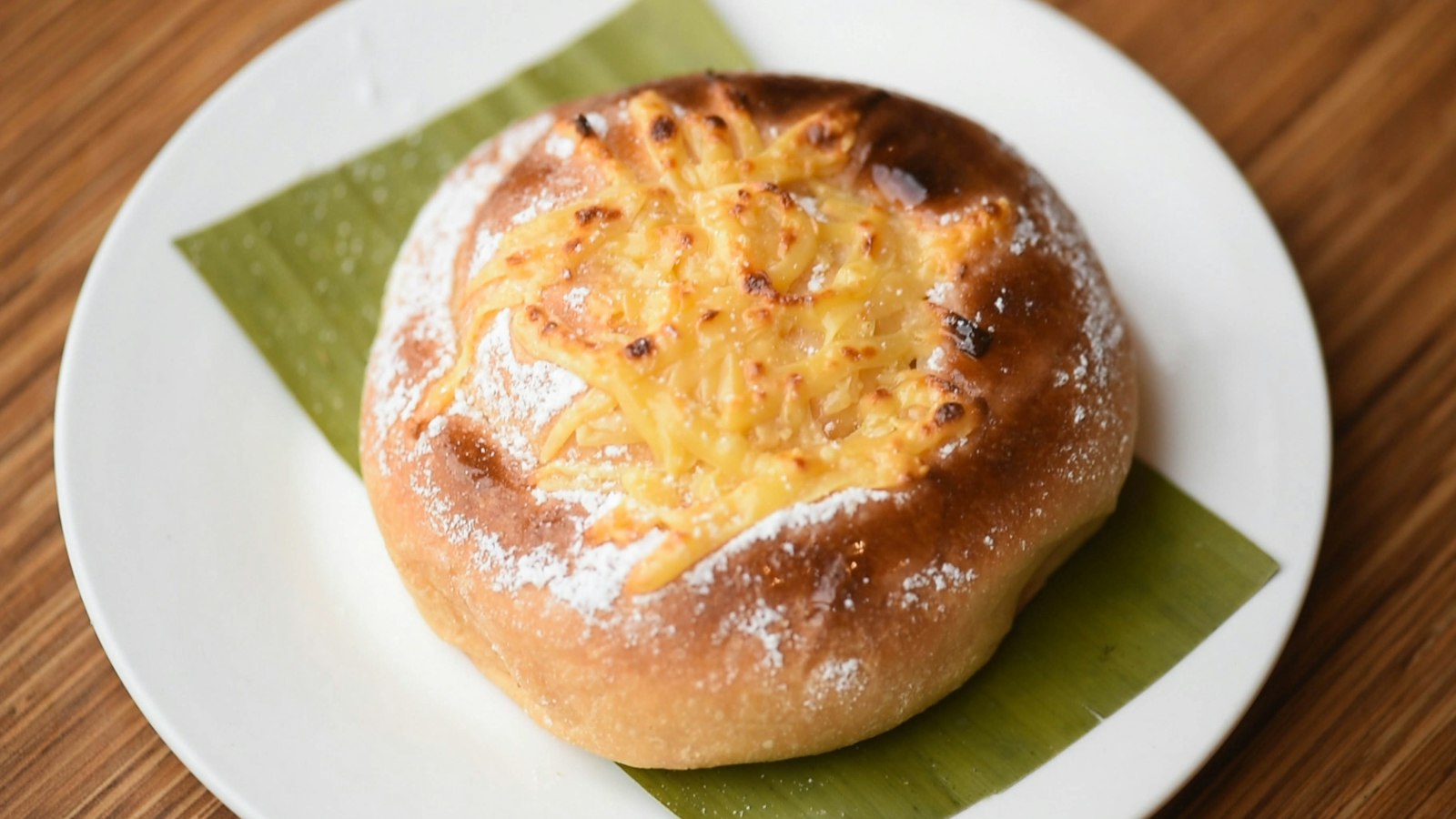 Filipino ensaymada sweet bread with cheese and sugar