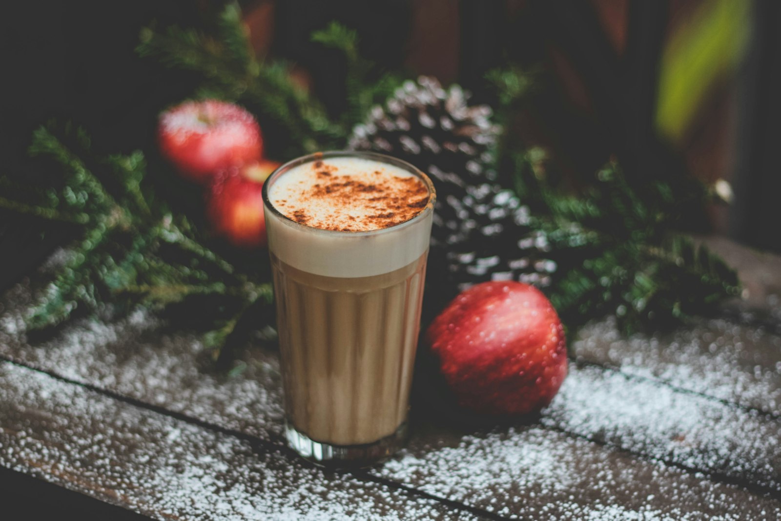 Spiced latte with whipped cream, apples and pine cones