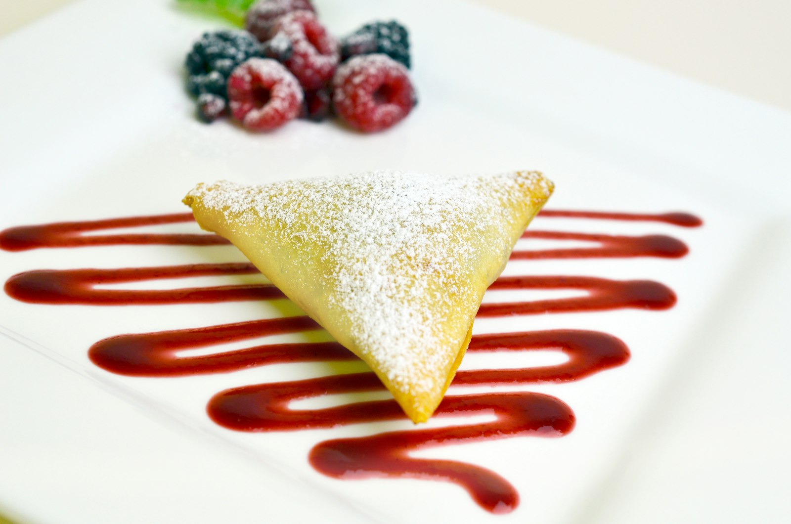 Berry turnover with berry sauce