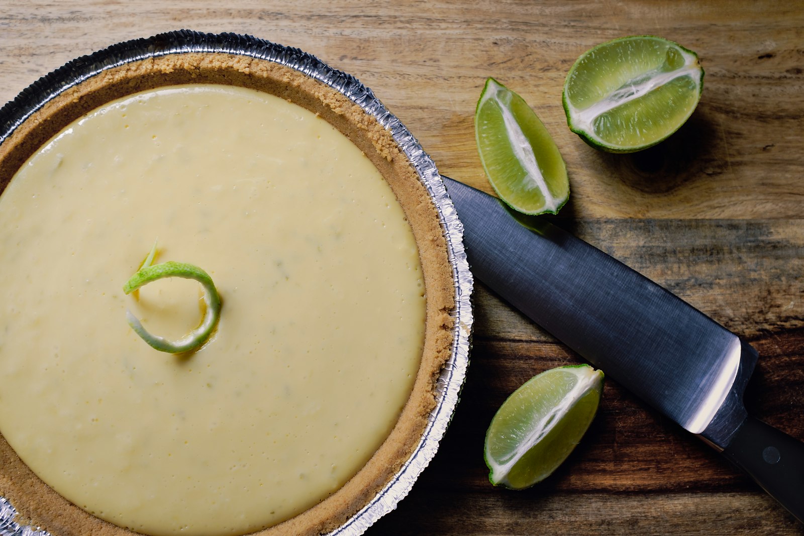 Key lime pie with a lime wedge and graham crust