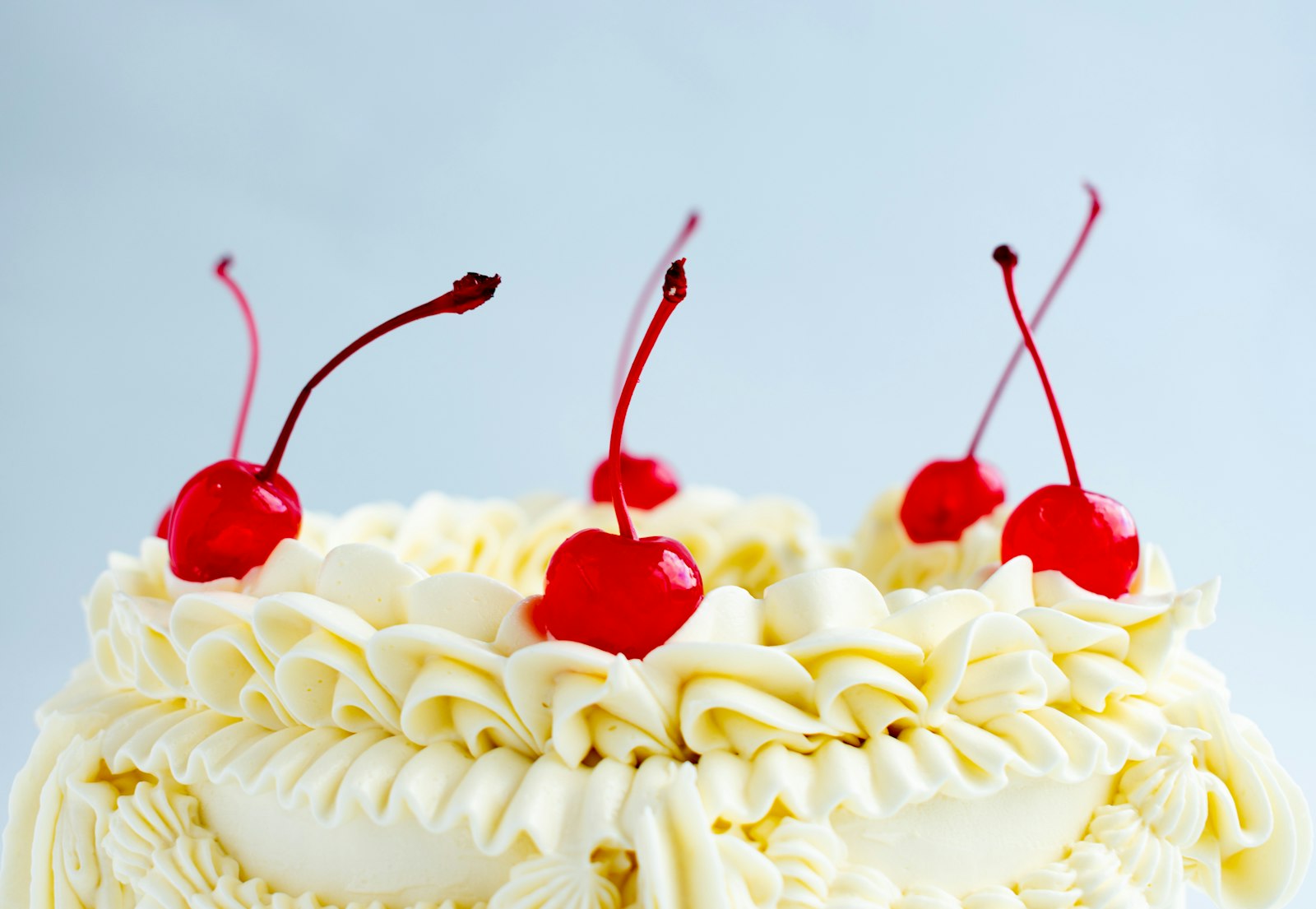 Lady Baltimore cake topped with cherries and frosting