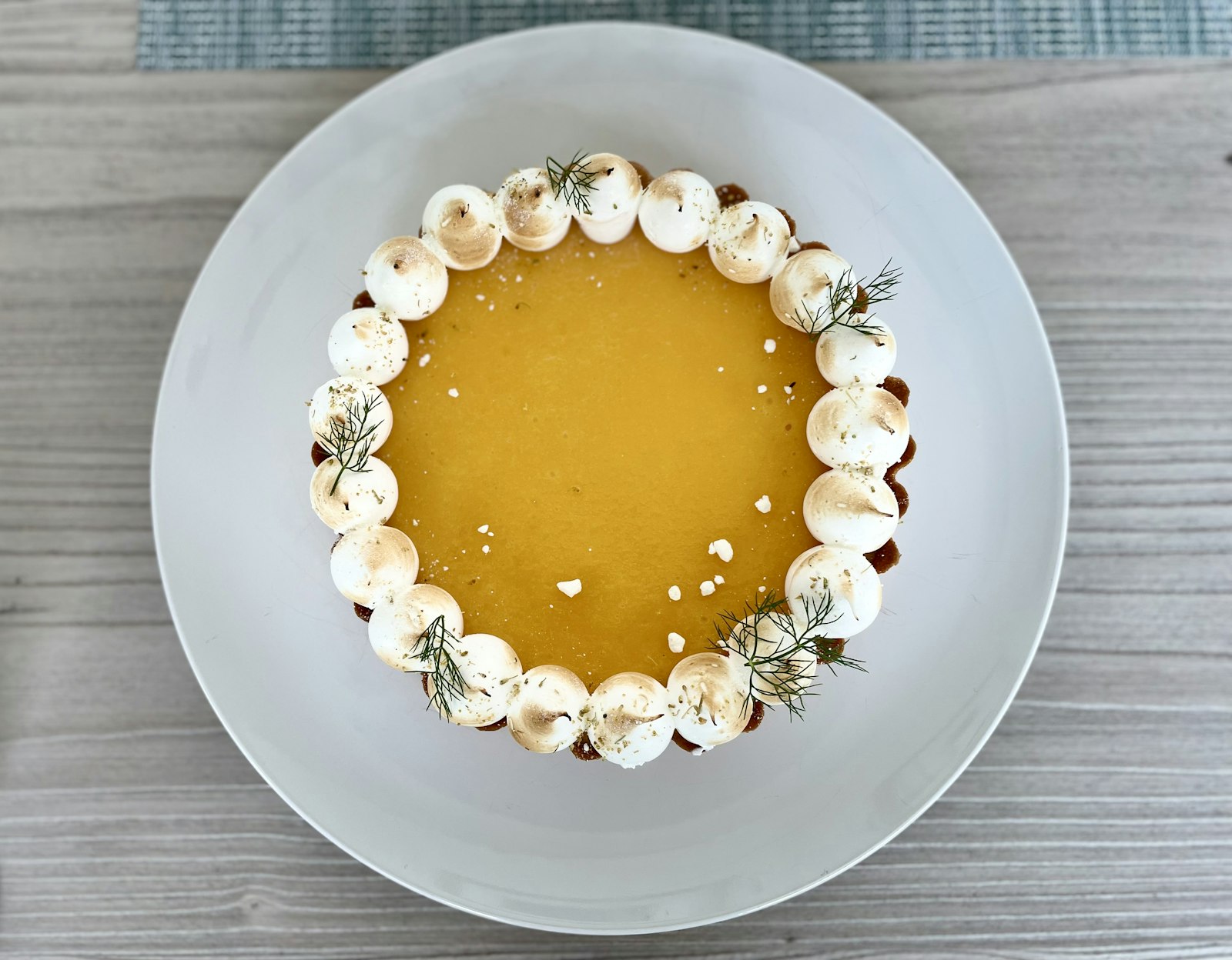 Bright yellow lemon tart with piped meringue dots