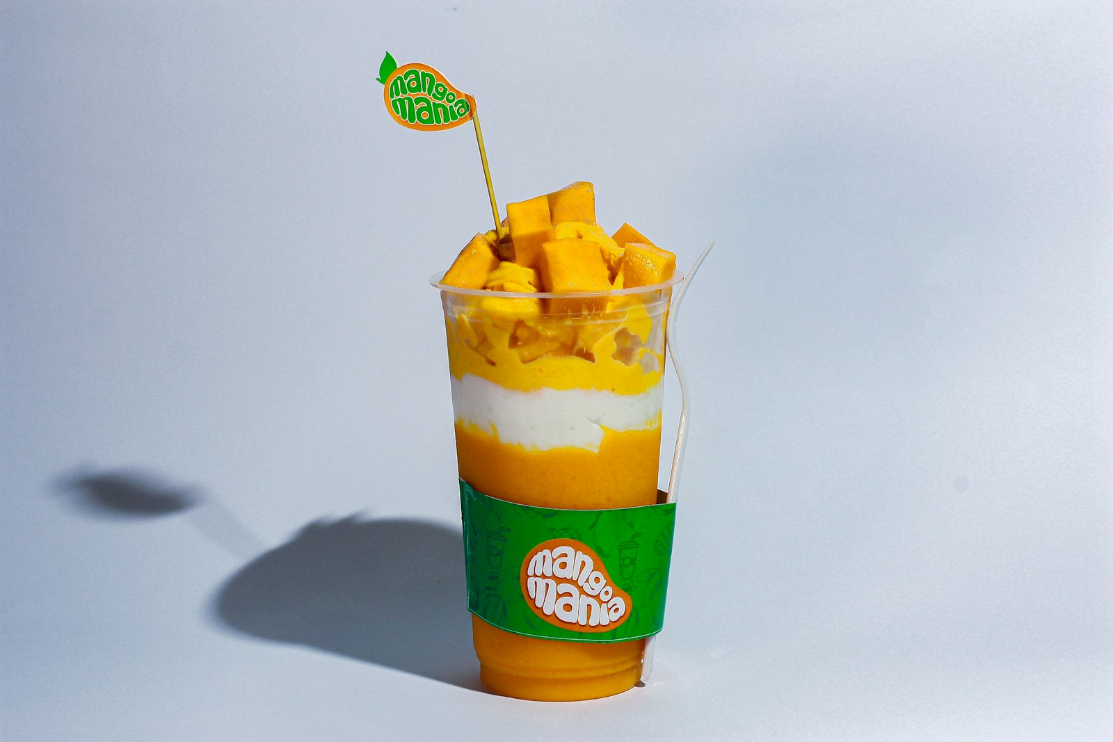 Layered mango float dessert in a cup
