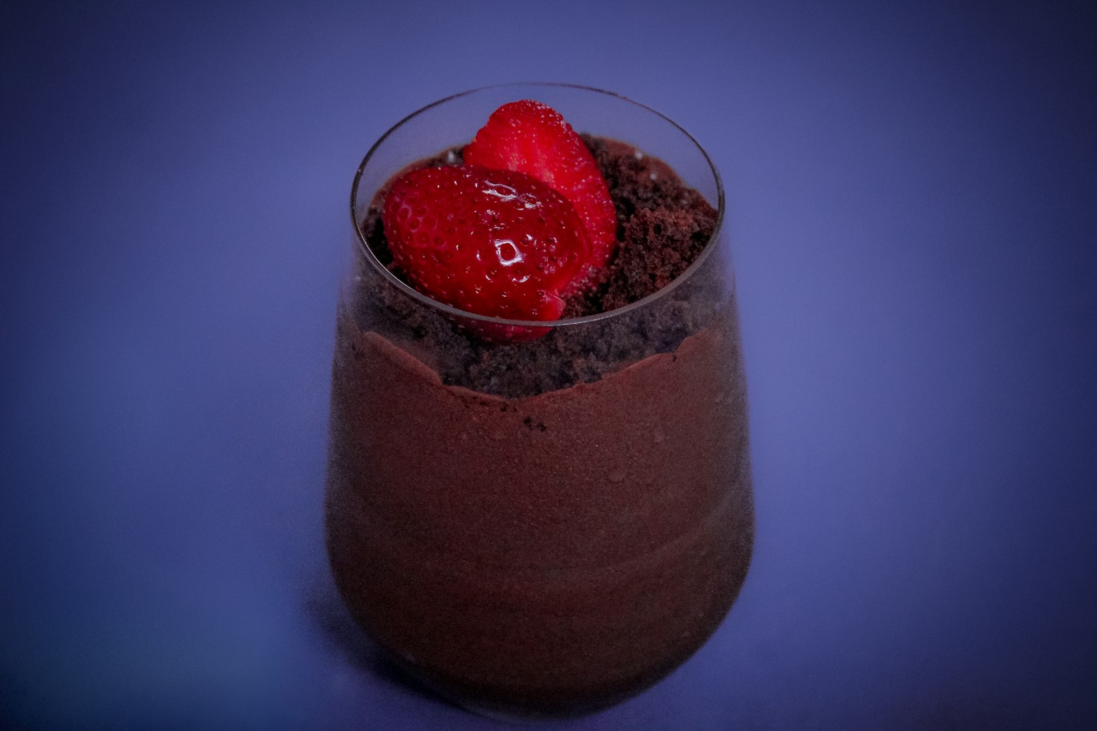 Chocolate mousse in a glass topped with a strawberry