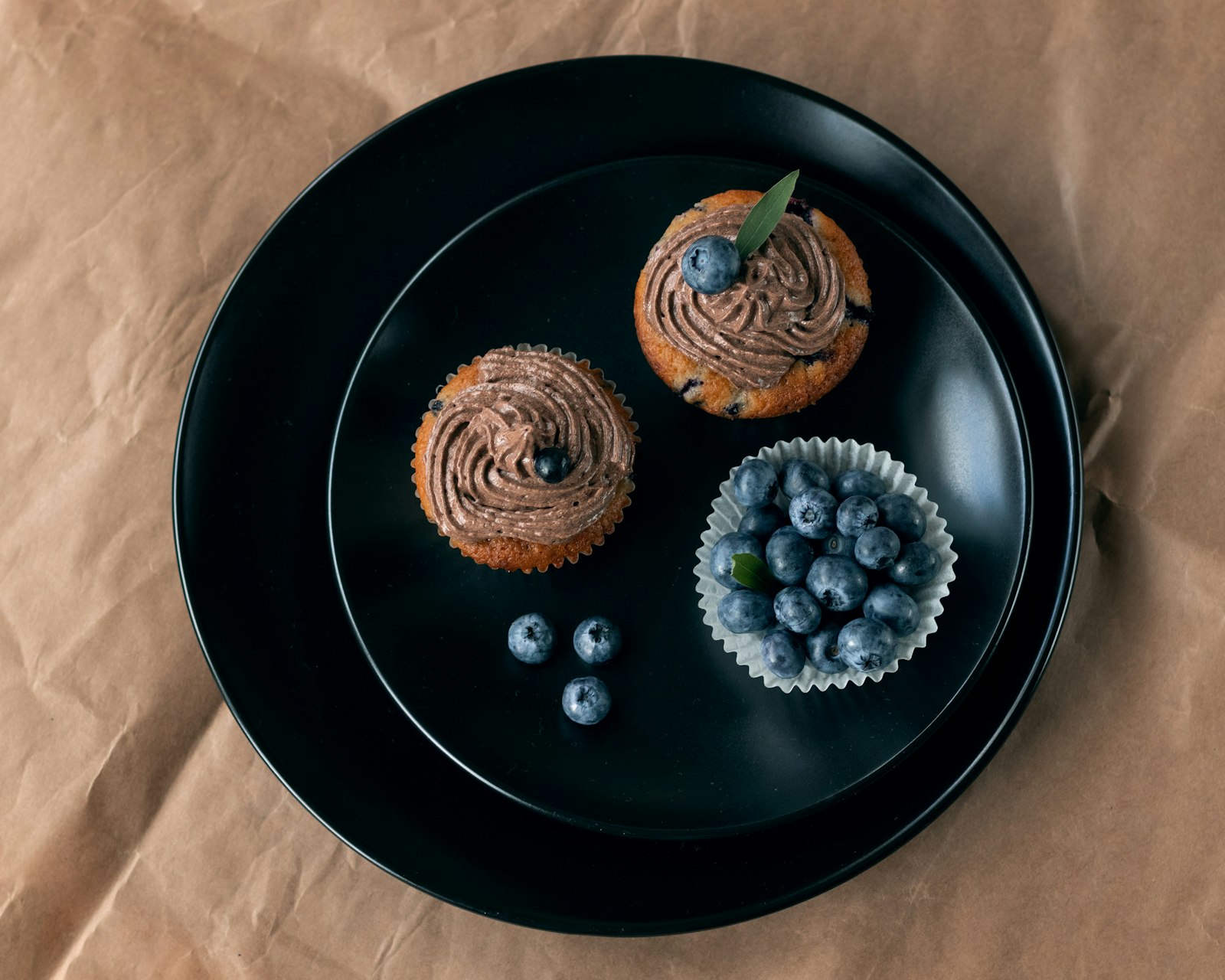 Blueberry muffins on a dark plate