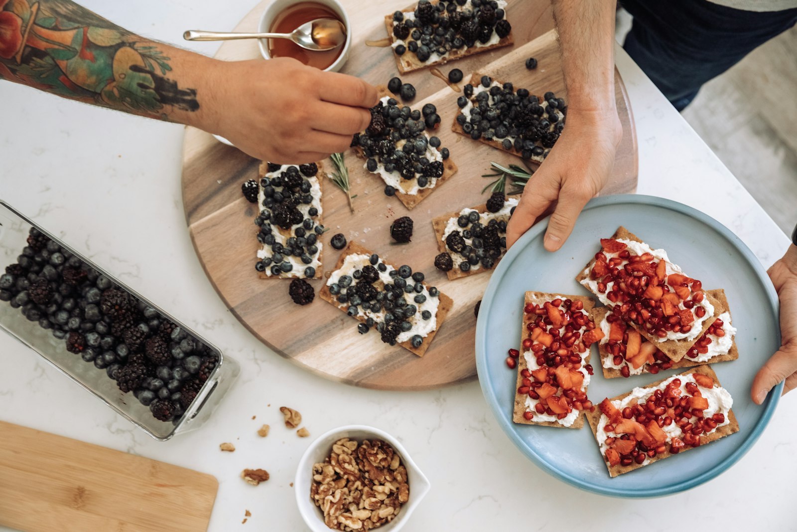 Crispbread topped with cream cheese, berries and pomegranate