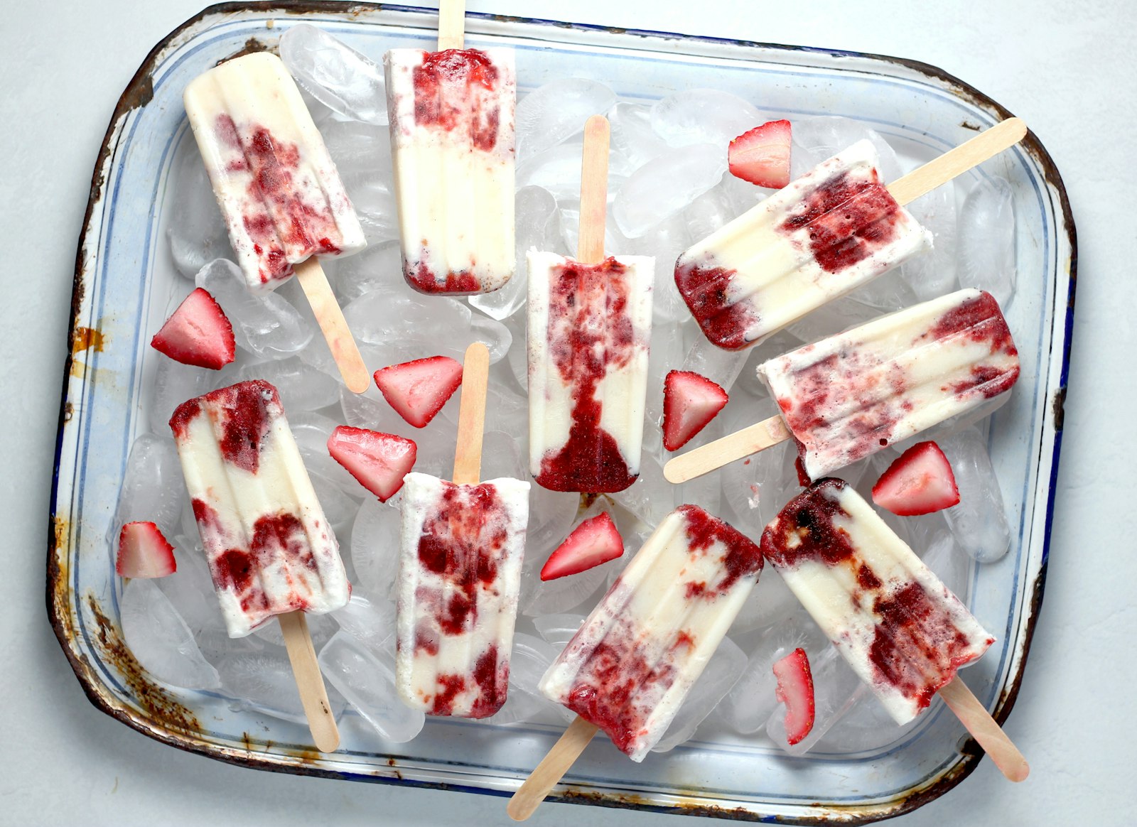 Homemade berry popsicles on ice