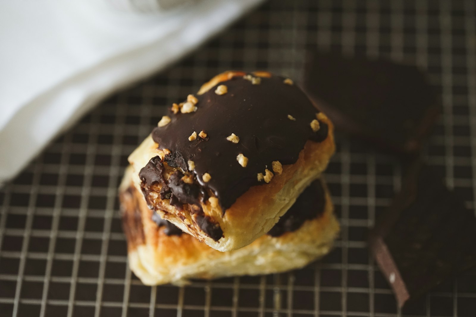 Chocolate topped pastry bar with nuts