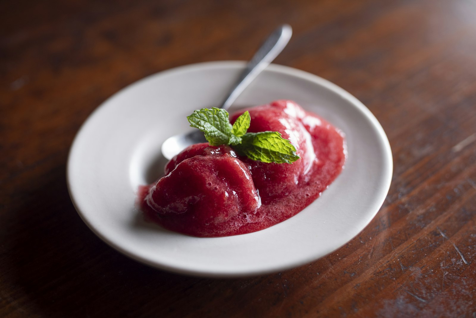 Strawberry sorbet with mint in a white bowl