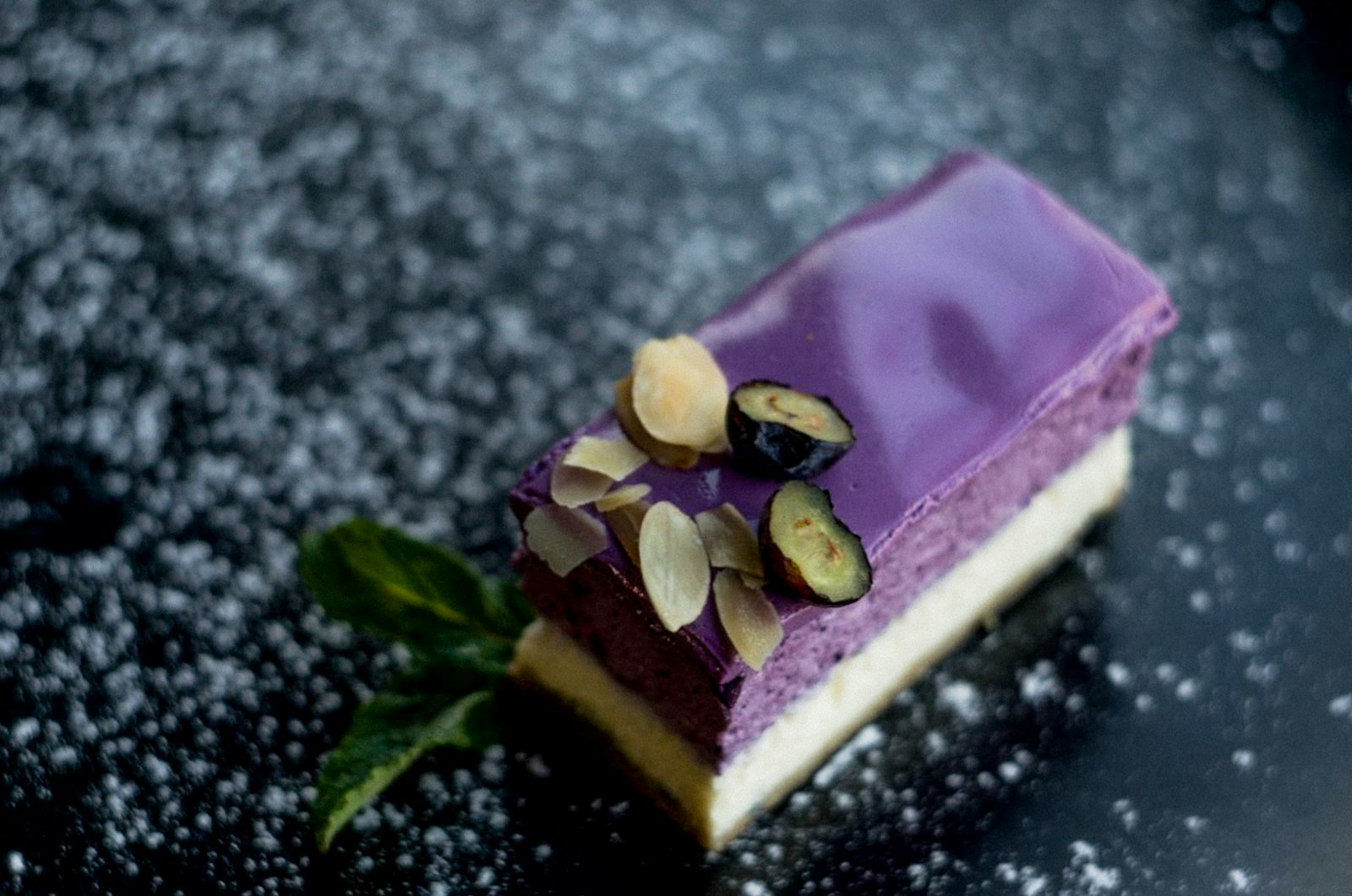 Purple ube cake slice with nuts and blueberries