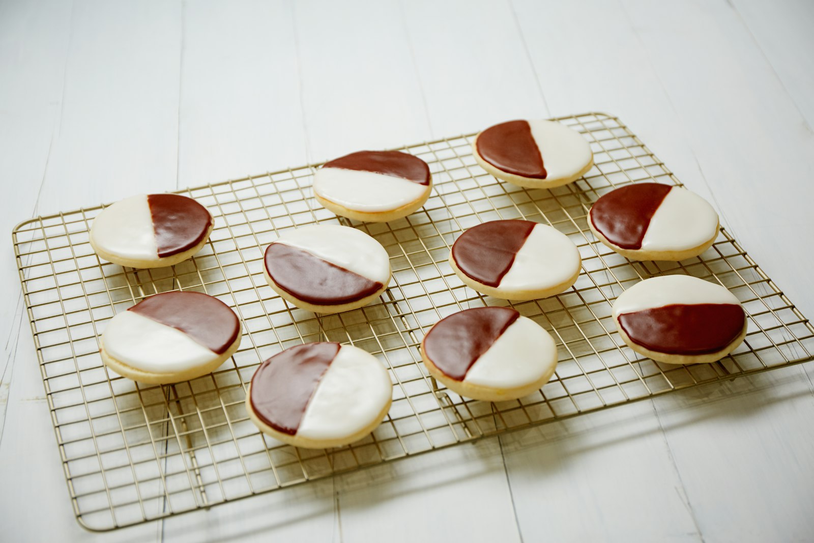 Black and white cookies on a cooling rack