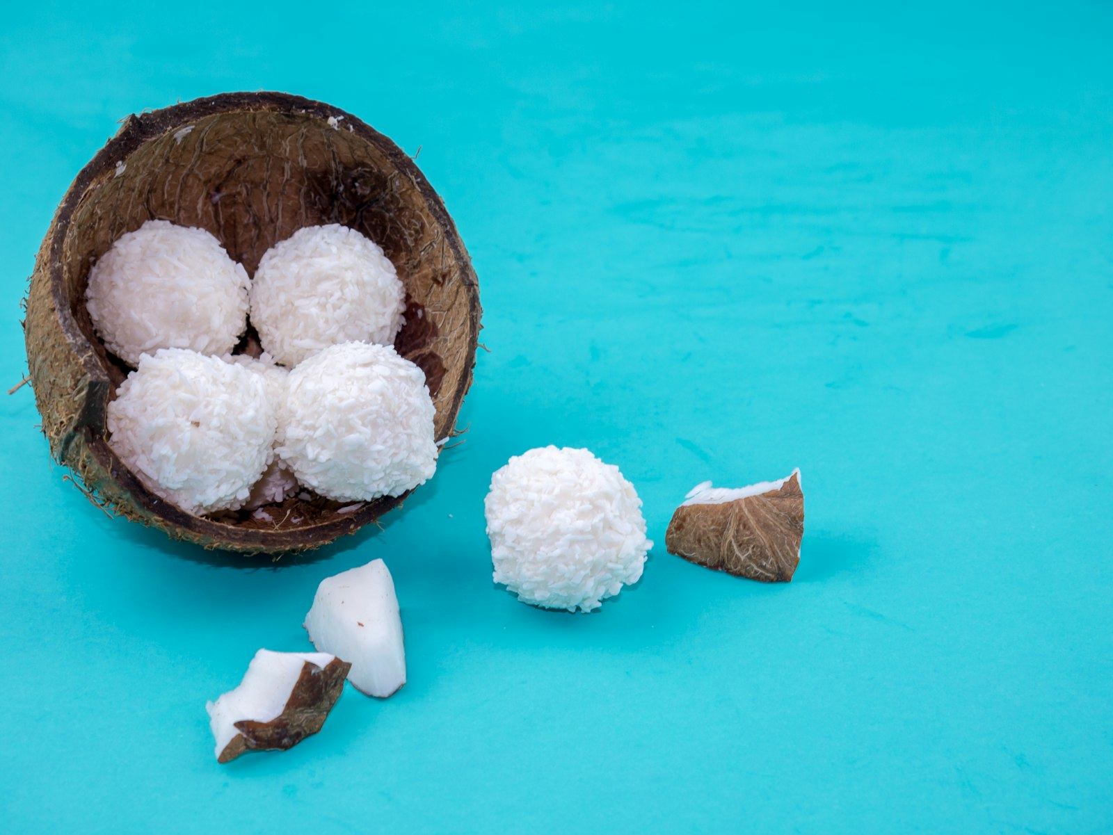 Coconut snowball treats in a coconut shell