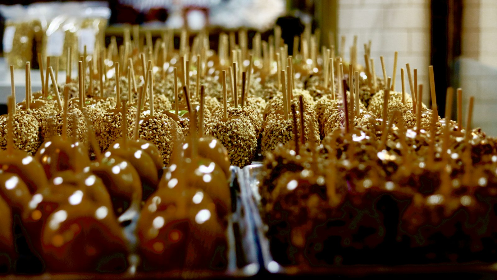 Rows of caramel apples on sticks