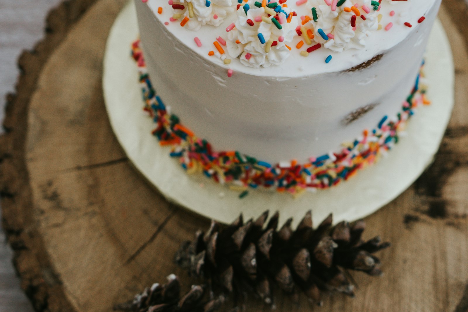 White frosted cake with rainbow sprinkles