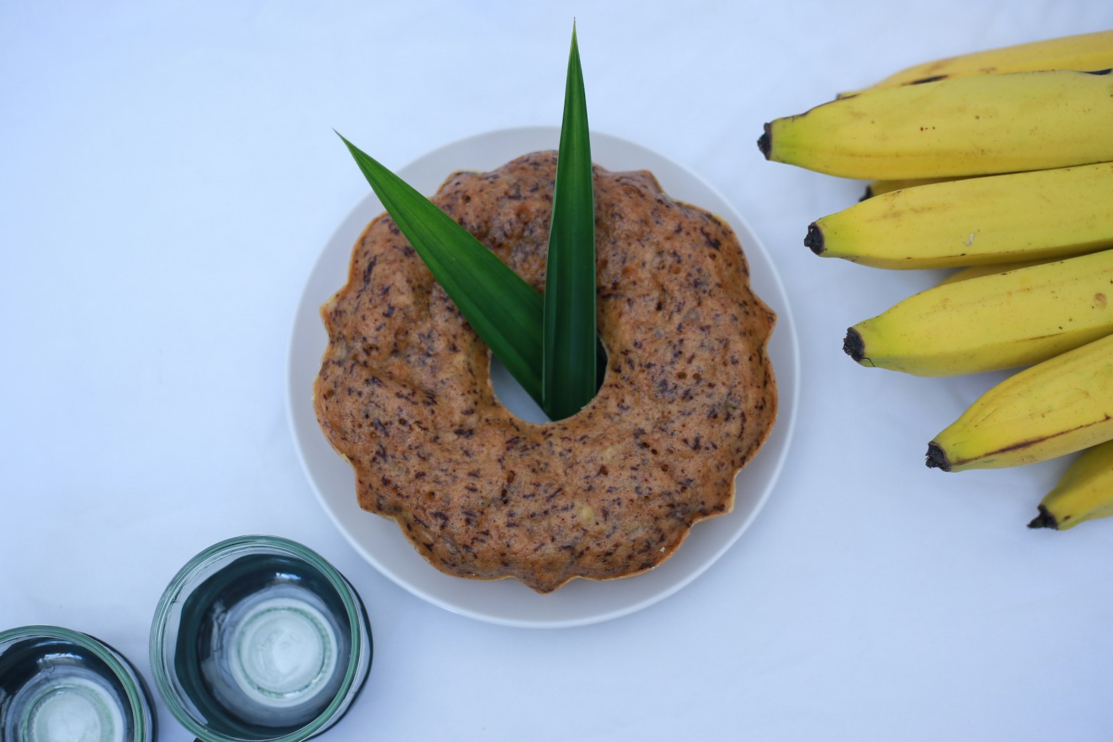 Banana cake with fresh bananas on the side