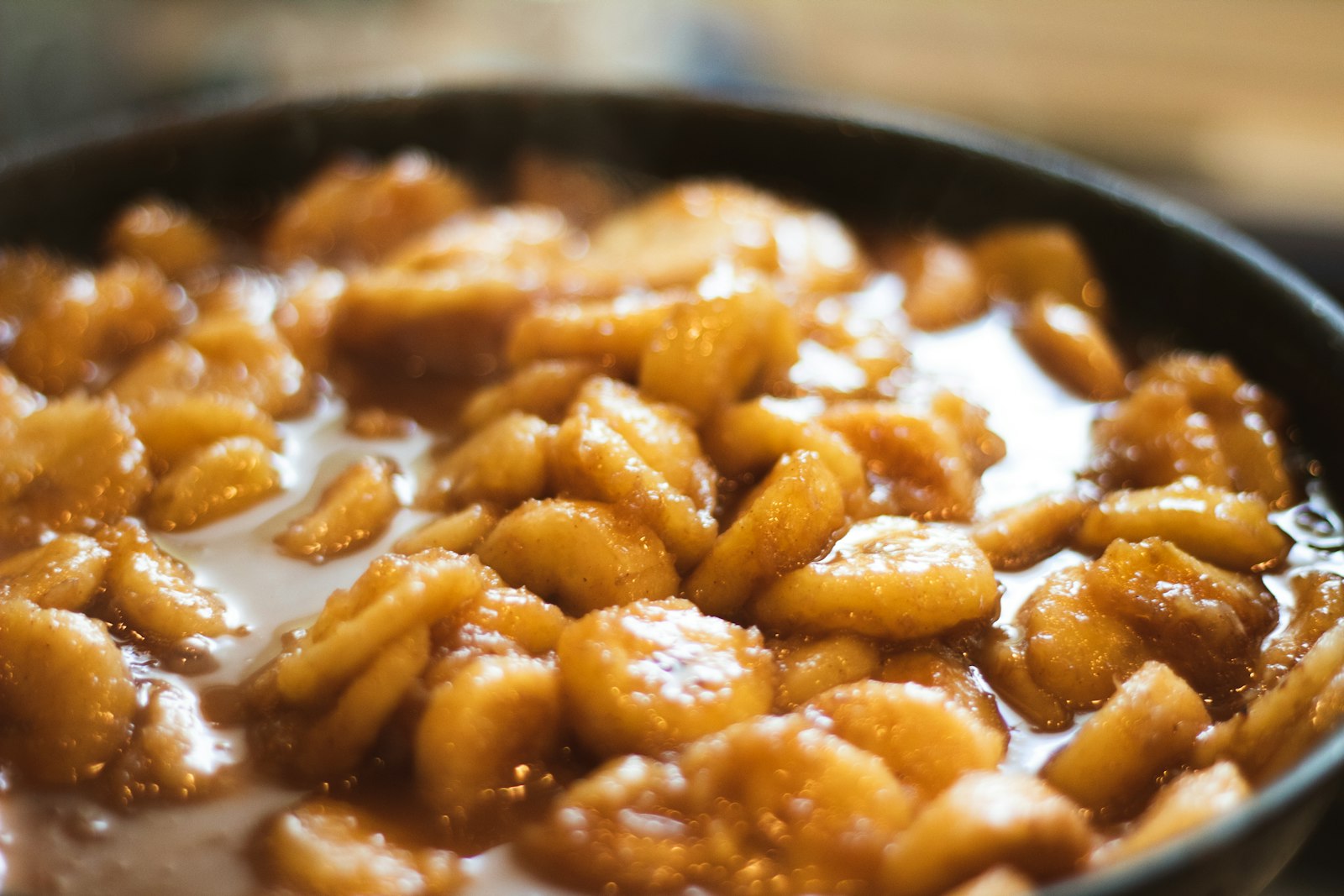 Pan of caramelized fruit in buttery sauce
