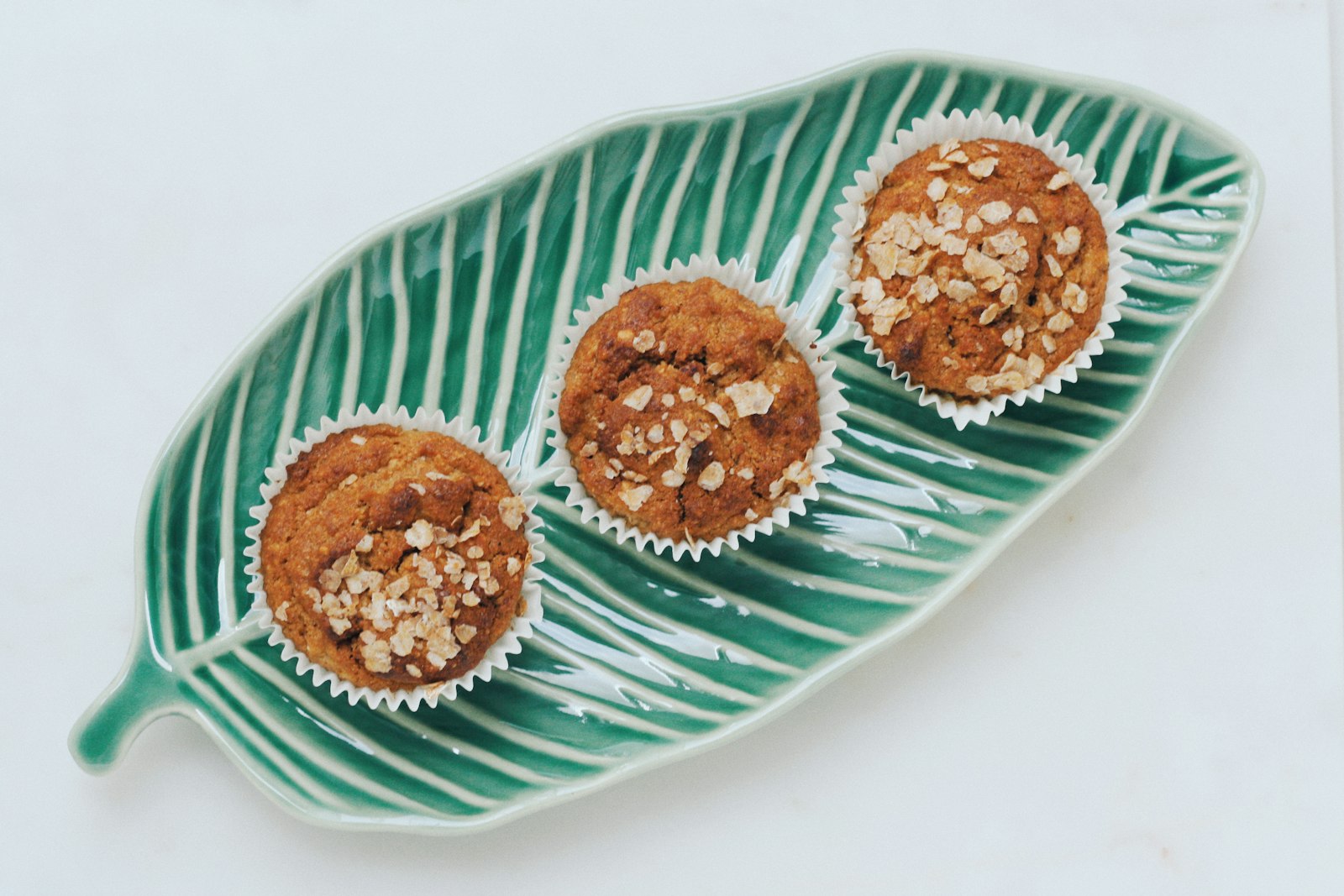 Homemade muffins on a green leaf plate
