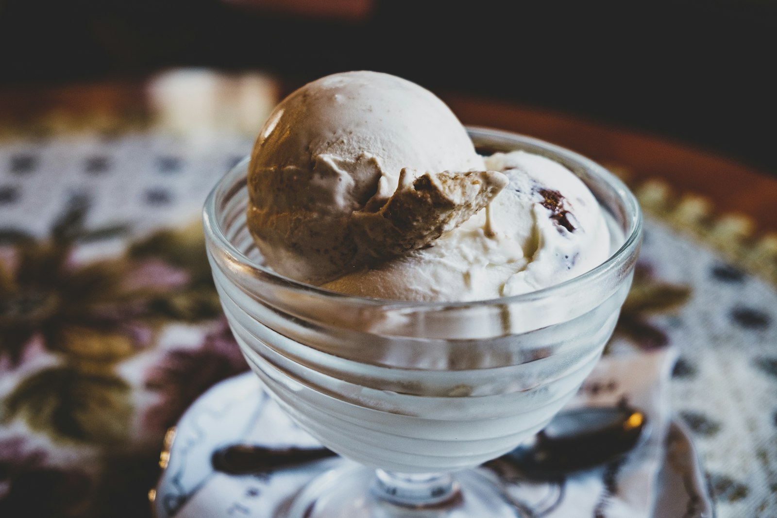 Scoops of walnut ice cream in a glass bowl
