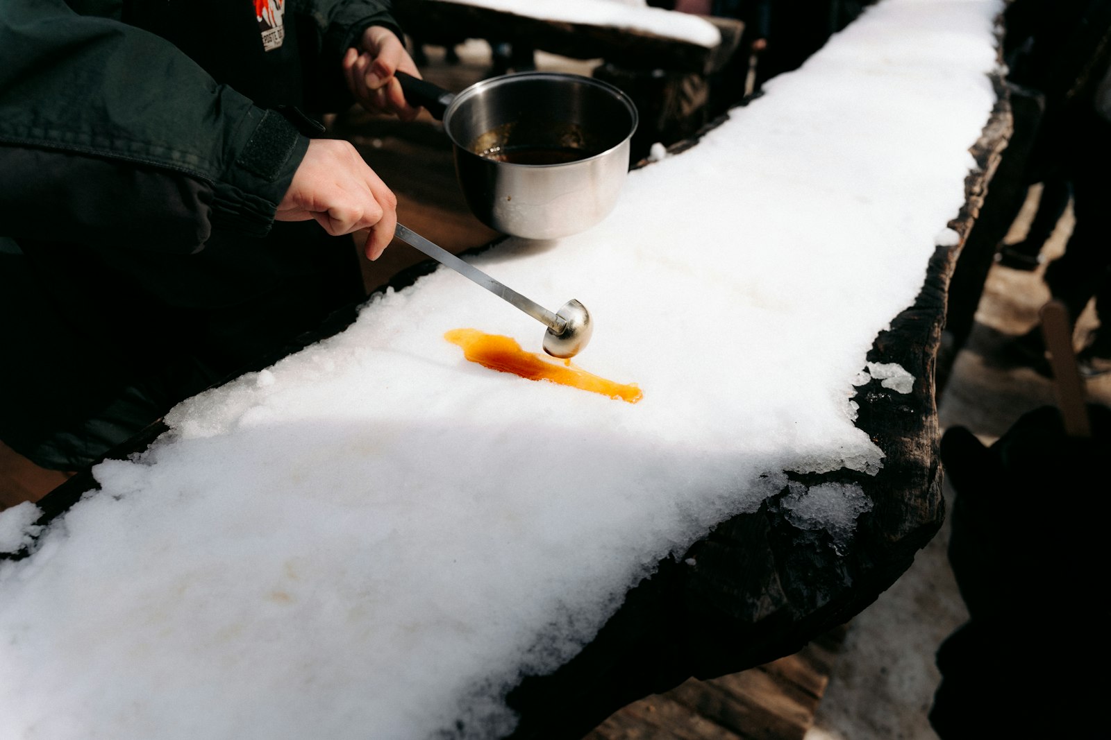 Pouring hot maple taffy on fresh snow