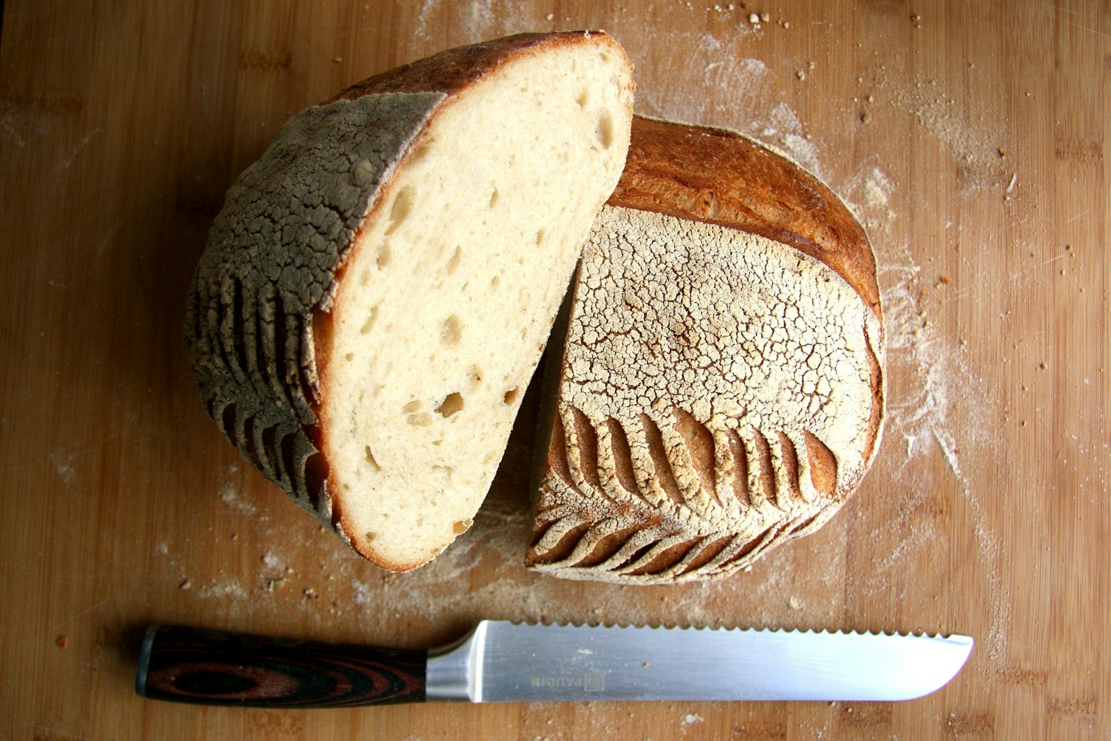 Sliced loaf with a knife on a wooden board