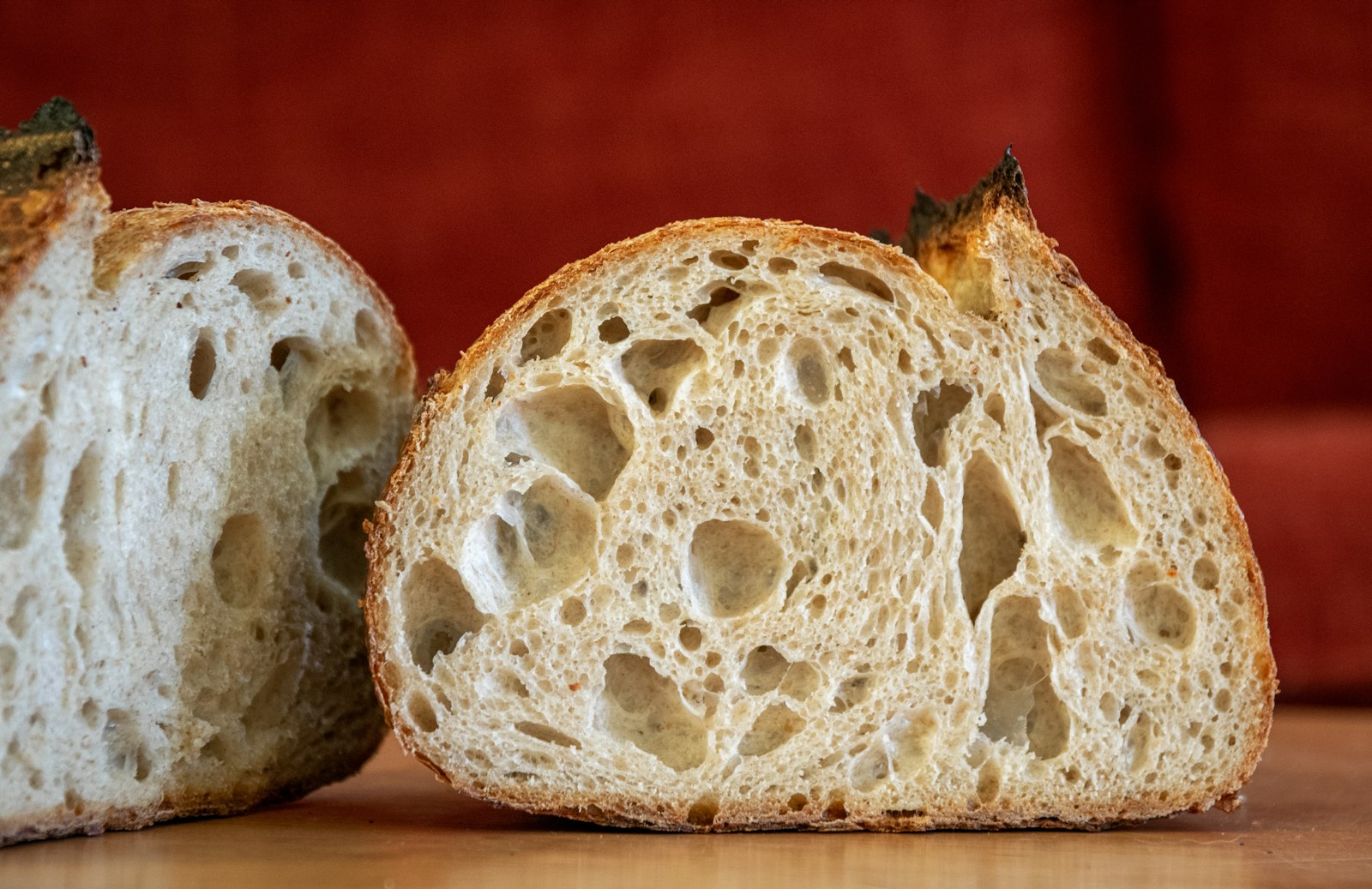 Airy open crumb inside a halved loaf