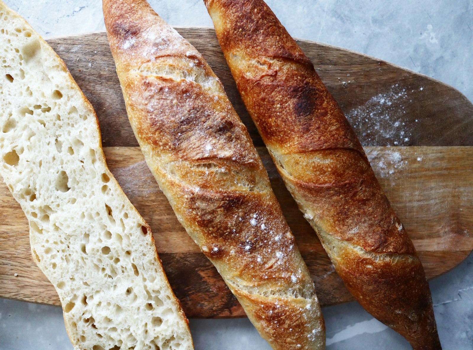 Long rustic baguettes on a wooden table