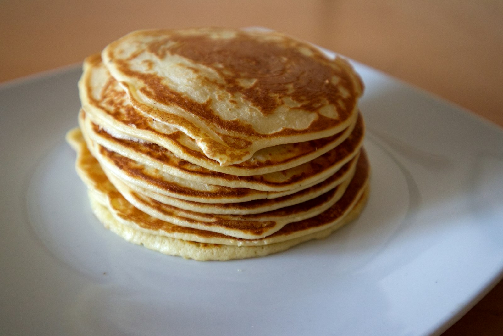 Tall stack of fluffy pancakes on a plate