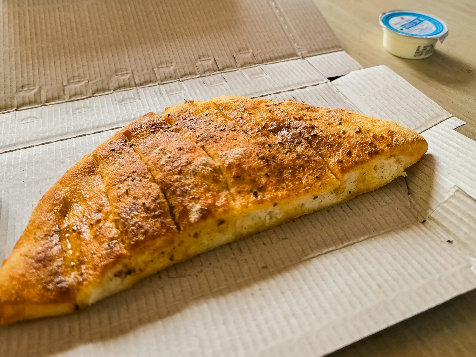 Stuffed and rolled stromboli on baking paper