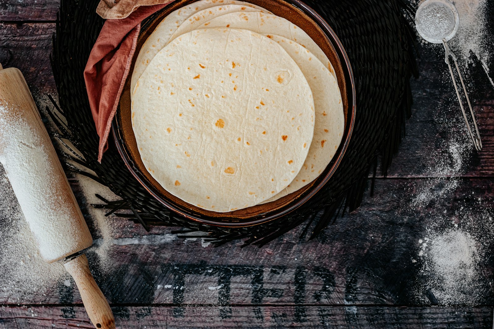 Homemade flour tortillas in a rustic bowl