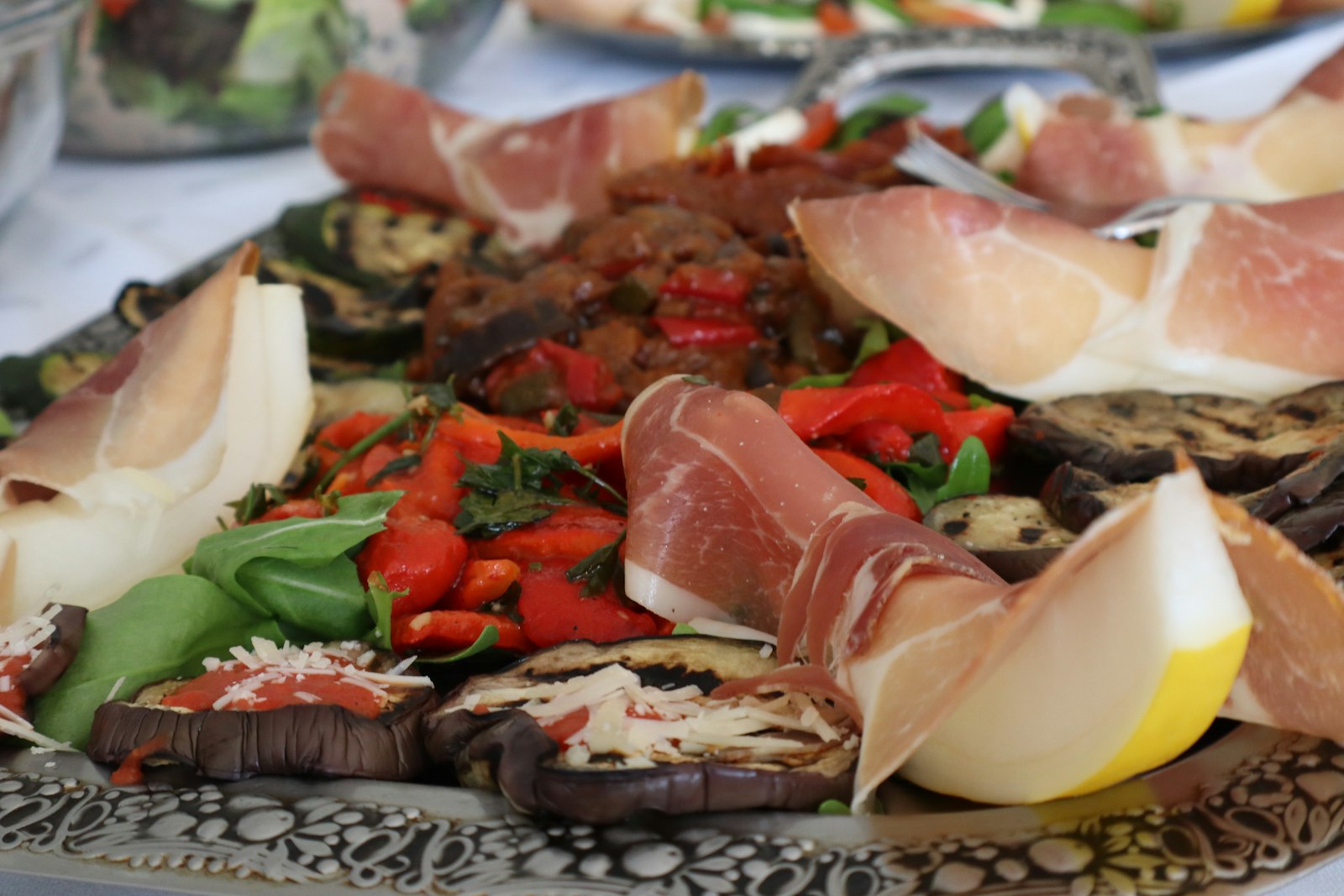 Antipasto platter with prosciutto, melon and vegetables