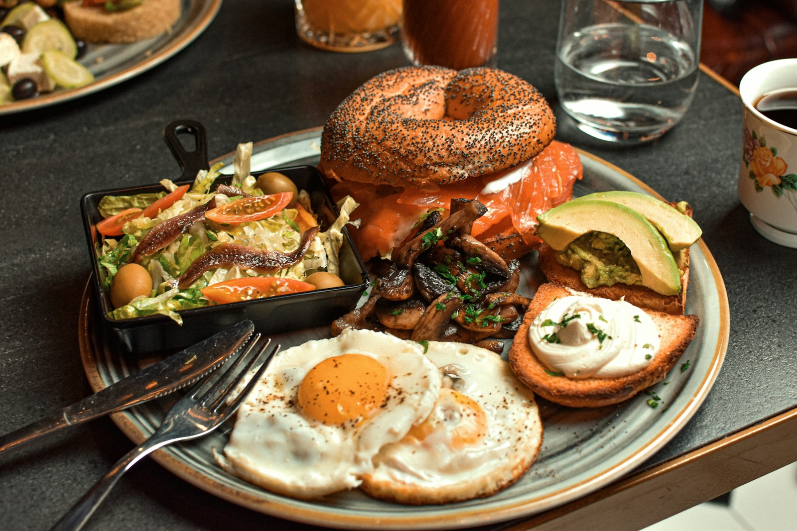 Bagel brunch board with eggs, avocado and coffee
