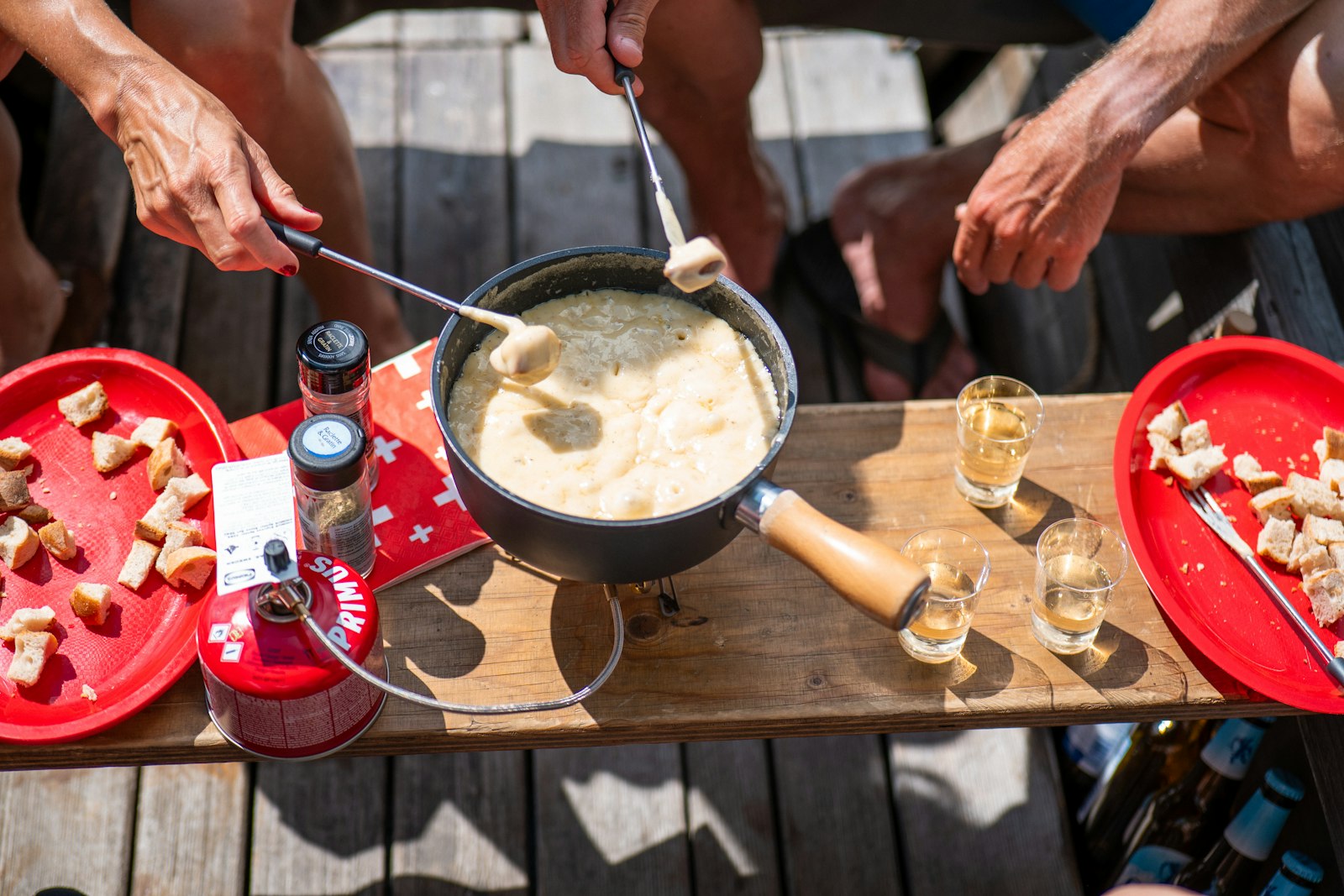 Fondue party table with cheese, meats and dippers